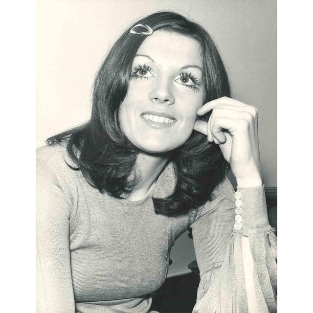 A vintage gelatin silver press photograph depicting Caterina Caselli (b. 1946), one of Italy's most iconic pop singers of...