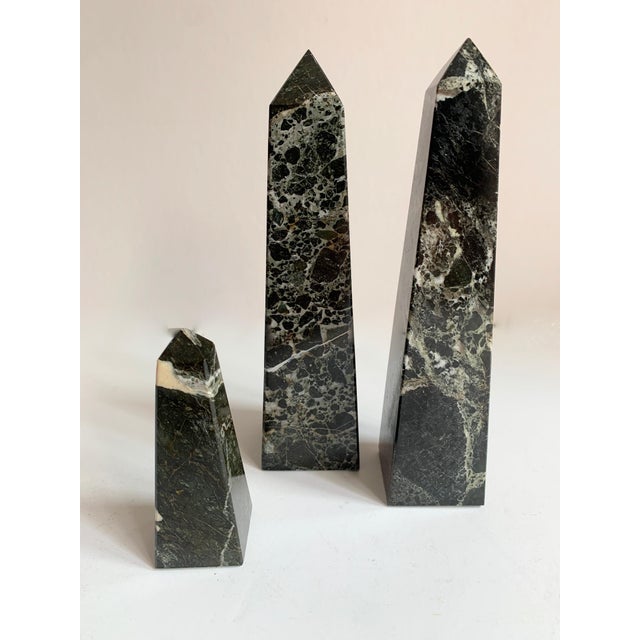 Three black marble obelisks. The trio are a nice decorative addition to the desk or shelf, however could easily be paper...