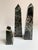 Three black marble obelisks. The trio are a nice decorative addition to the desk or shelf, however could easily be paper...