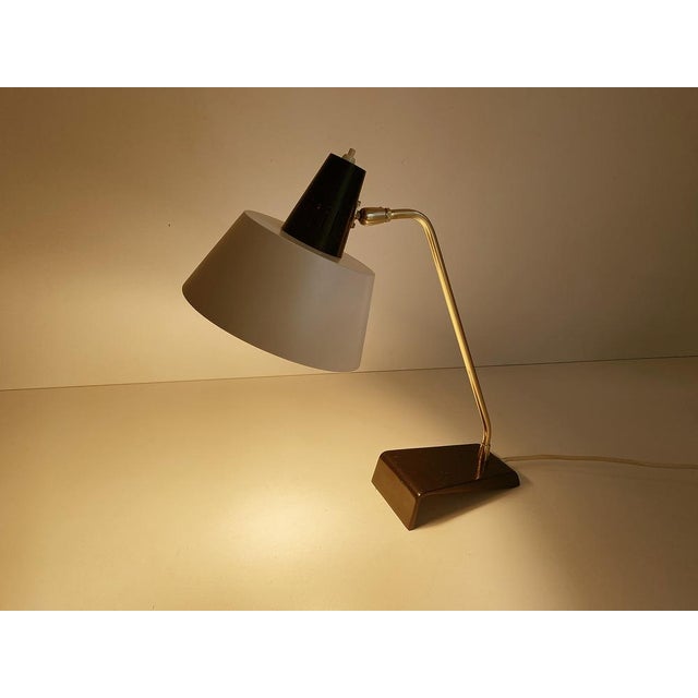 Kaiser Desk lamp, Modell 6813, 1960s, featuring a cantilivered black enameled cast iron base, brass stem and superimposed...