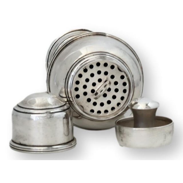 A handsome early 20th century English silverplate cocktail shaker with all of its original internal components, including...