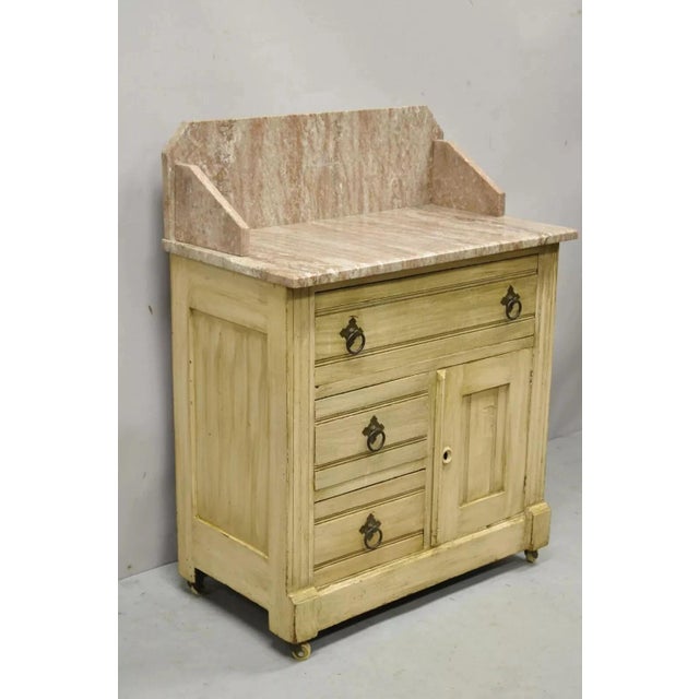 Antique Eastlake Victorian Pink Marble Top Backsplash Washstand Nightstand Cabinet. Item features one swing door, no key,...
