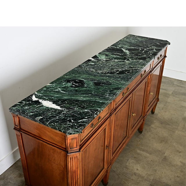 This 19th century Louis XVI style walnut enfilade is topped with an exciting slab of Verdi Alpi marble that beautifully...