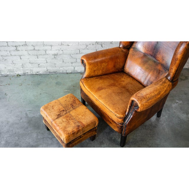 1970s Vintage Art Deco Distressed Cognac Leather Wingback Chair & Ottoman For Sale - Image 14 of 16