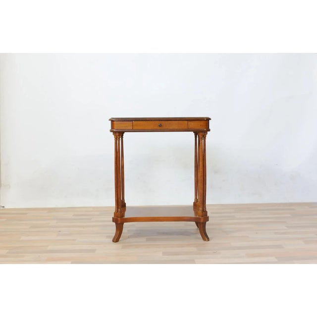 Table with eight turned columns, mahogany, production of the sixties, a central drawer, floor burl tuja with end ebonized...