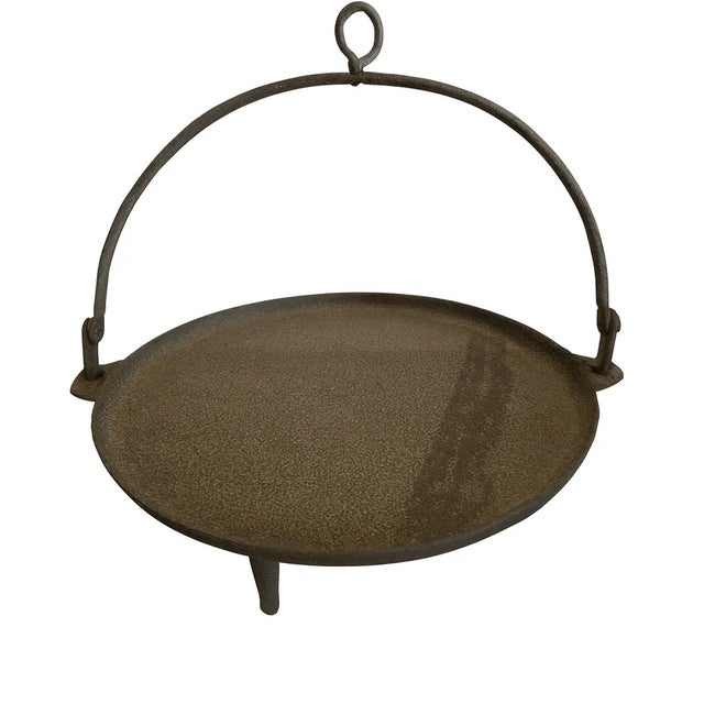 Authentic 19th-century cast-iron hearth spider griddle, a classic example of early American fireplace cookware. This...