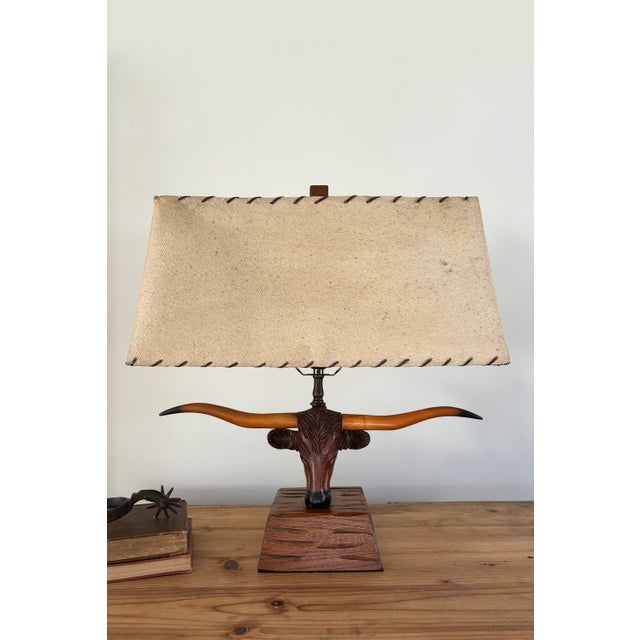 Vintage charm abounds with this rare 1950s carved Texas Longhorn steer lamp made by A. Brandt Ranch Oak Furniture Co. This...