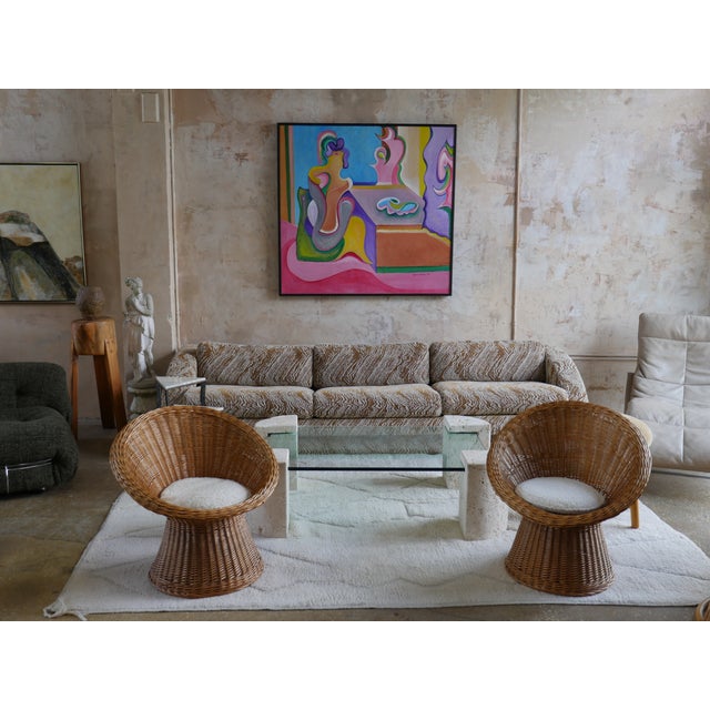 Beautiful pair of Mid-Century rattan, wicker weave lounge chairs with new boucle, off-white colored upholstery from french...