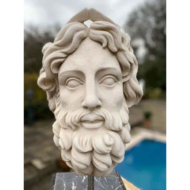 Wonderful marble bust of the roman god of the water neptune. Gorgeous piece standing on a black marble pedestal base....
