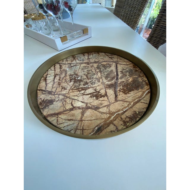 Elevate your entertaining experience with this Brown Marble and Brass Serving Tray. This exquisite piece blends the...