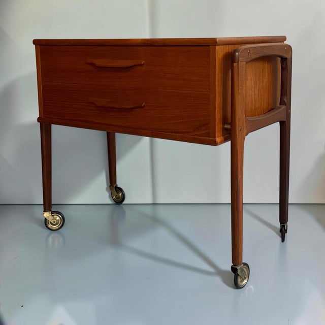 Elegant Danish mid-century trolley or side table crafted in teak, dating from the 1960s. The piece features two practical...