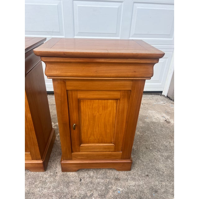 Elegant pair of 19th century Louis Philippe nightstands crafted from warm walnut with clean, classic lines. Each features...