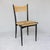 These four Gio Ponti-style dining chairs have rush seats and backs. The chair frame is wood, painted black.
