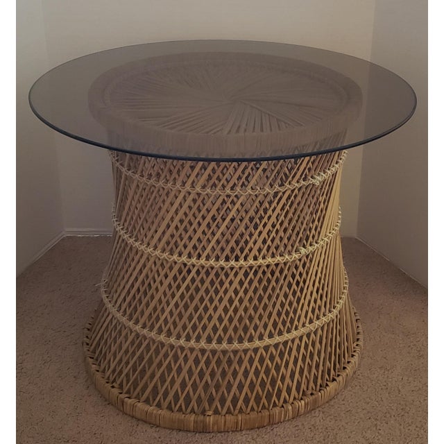An exceptionally stylish Mid-Century Modern wicker and rattan side table distinguished by its intricately woven lattice...