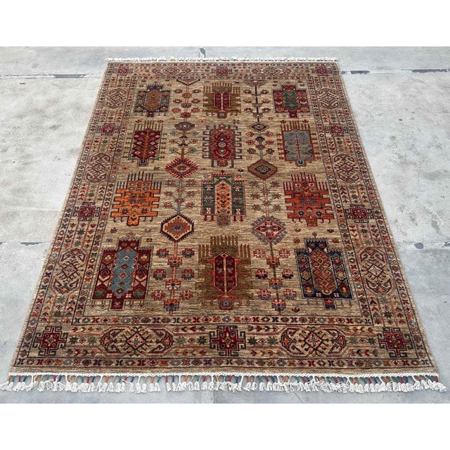 This Caucasian Tribal Wool Rug beautifully captures the essence of traditional weaving with its bold geometric motifs and...