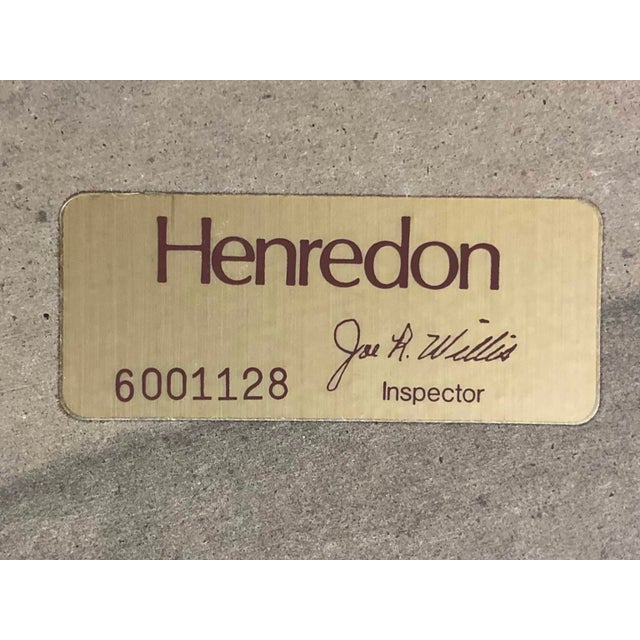 This is a Henredon postmodern black lacquer and faux tusk coffee table with a beveled glass top and brass trim. The glass...