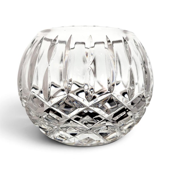A late twentieth-century clear cut-crystal rose bowl of substantial weight and compact globular form, distinguished by an...