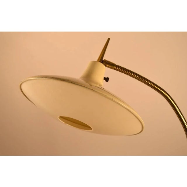White enamel and brass gooseneck floor lamp, in the style of Gio Ponti. By Laurel Lamp Company. Very good original...
