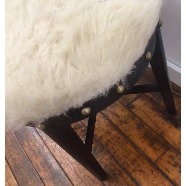 Vintage one of a kind stool. Black finish on wood. Seat is creme faux fur (also vintage). Large brass decorative ornaments...