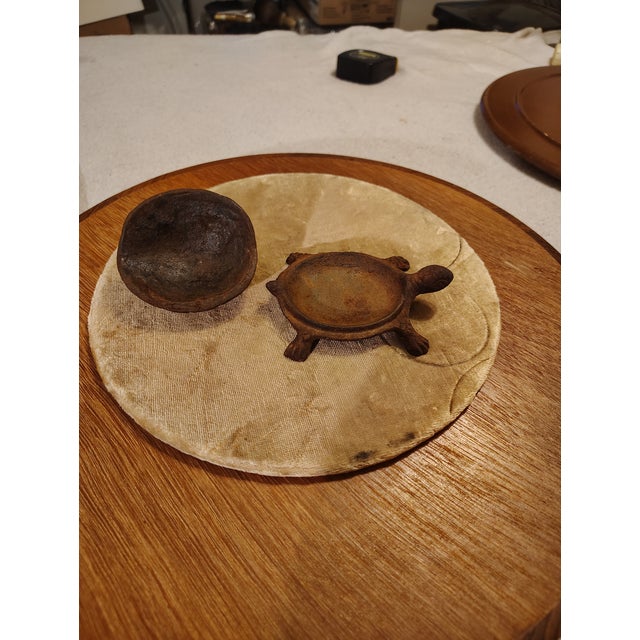 My Grandmother had this turtle when I was a boy it's cast iron and was kept in the yard as a decoration it has writing on...