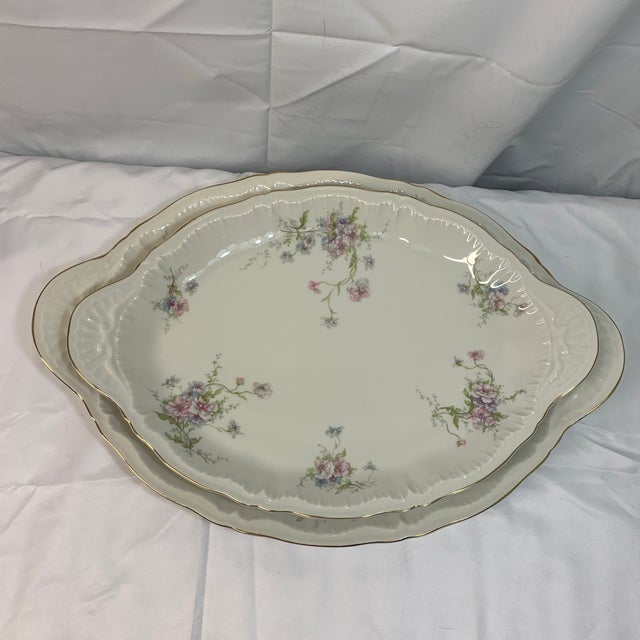 Elevate your next gathering with timeless porcelain elegance. This matching set features two beautifully graduated oval...