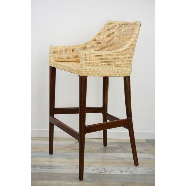 Stools made of a wooden frame and a woven rattan shell