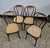 Set of four Thonet bistro chairs in bentwood with cane seats. We've all sat on a Thonet chair at some point; it's THE...