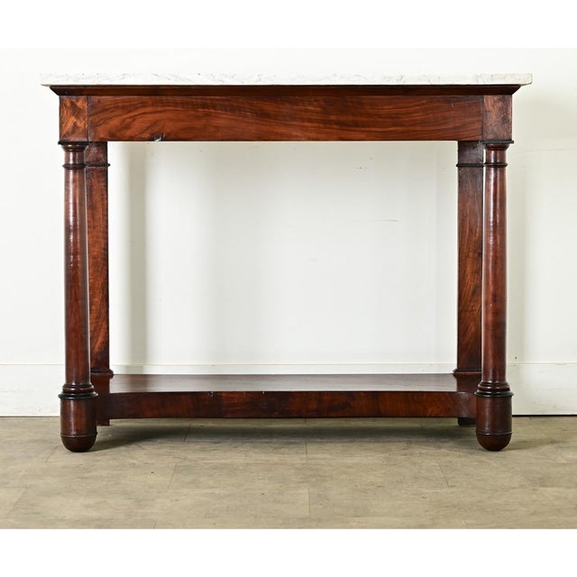 Dimensions: 35 ⅞” H x 45 ⅝” W x 19 ⅞” D A substantial French 19th century Empire mahogany console. The thick Carrara...