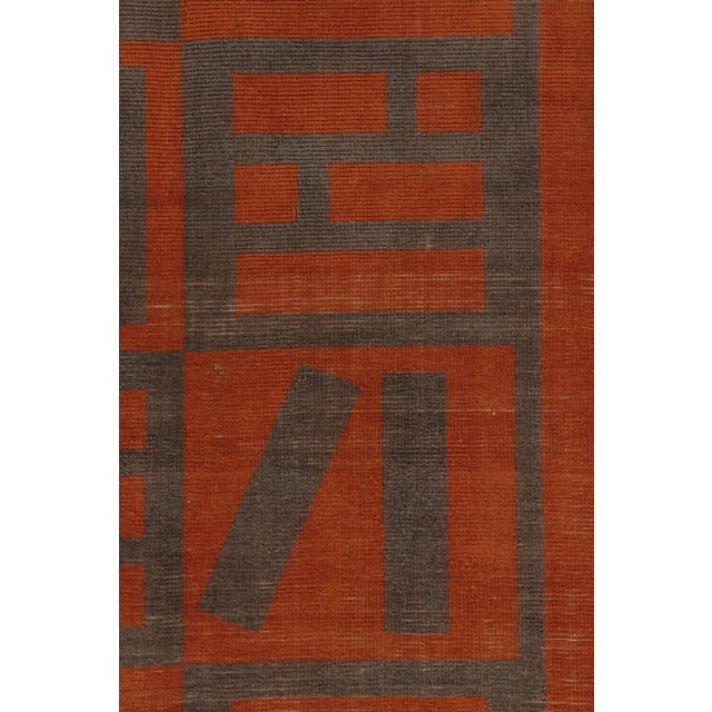 Hand-knotted in wool, this vintage Turkish 4x6 rug dates to circa 1950–1960 and features a bold geometric design in burnt...