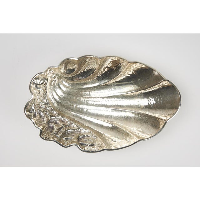 Centerpiece crafted from a hand-embossed 800-silver sheet with a distinctive hammered finish. Signed on the base, with...