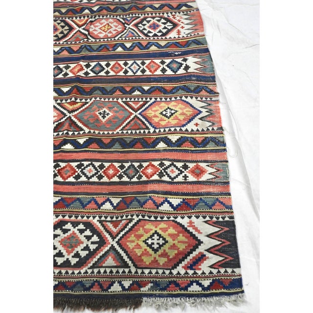 This is a lovely handwoven Turkish Kilim carpet runner. This rug features stripes of horizontal panels of scorpion,...