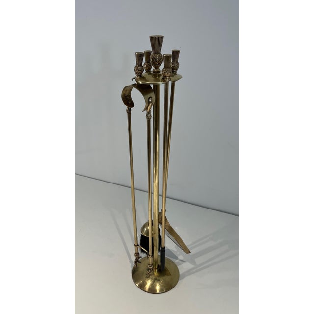 This freestanding neoclassical style fireplace tool is made of oak wood. brass. This is a French work. Circa 1970