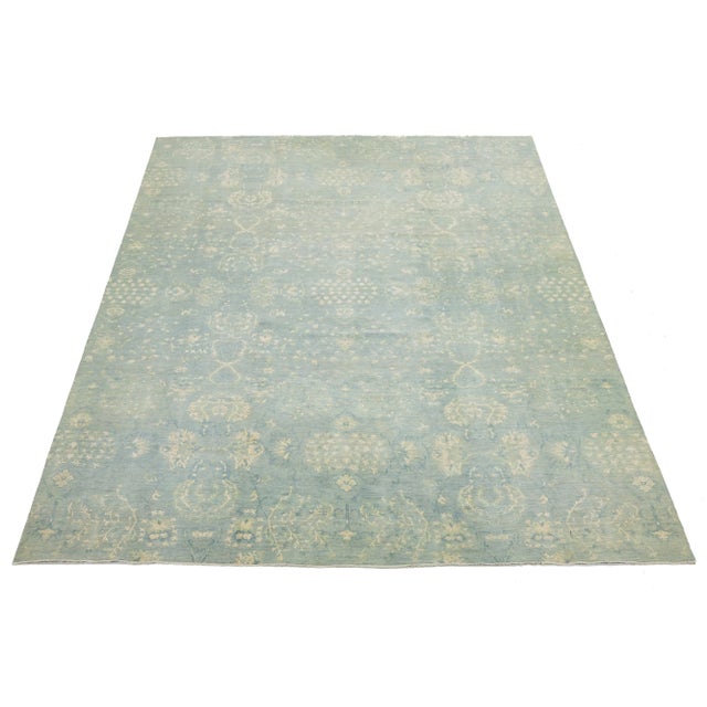 This contemporary hand-knotted rug features a striking floral design with a vibrant color scheme. Made from high-quality...