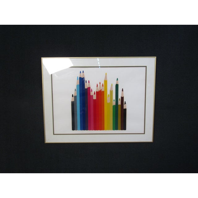 This framed artwork features an assortment of colored pencils against a white background. WEAR Some scuffs and scratches...