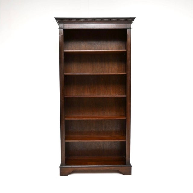 A tall and useful antique Georgian style open bookcase, made in England and dating from around the 1950’s. This is of...