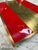 Bold and sophisticated vintage serving tray featuring a vibrant red lacquered surface accented by a brushed brass center...