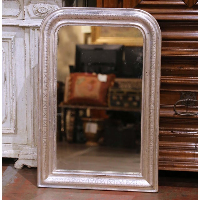 Crafted in France circa 1870, this elegant antique Louis Philippe wall mirror features the classic softly arched...