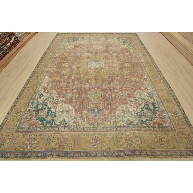 An authentic vintage traditional Tabriz rug hand-knotted with fine wool and natural dyes. This oriental rug features a...