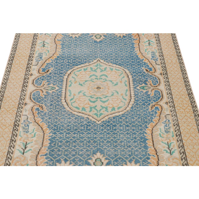 Hand-knotted in wool, this 4x6 vintage rug originating from Turkey, circa 1960-1970, is a very special piece, featuring a...