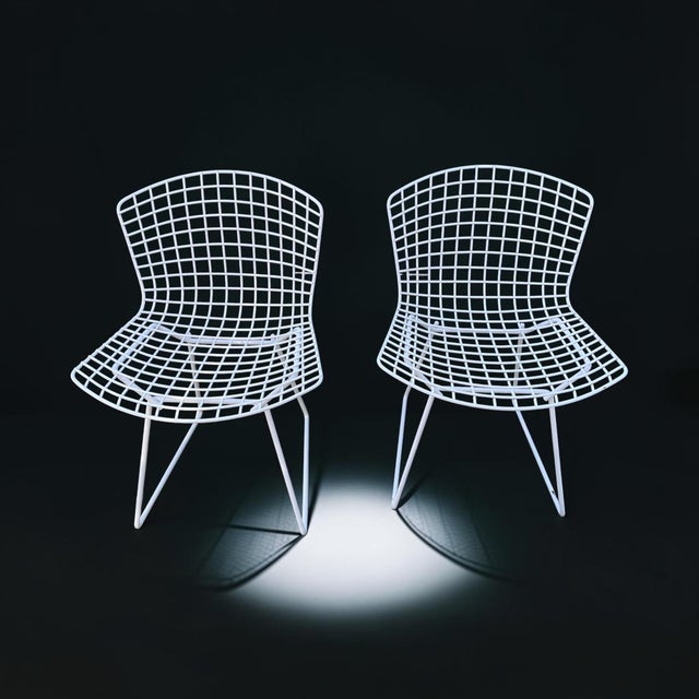 A timeless pair of authentic Harry Bertoia for Knoll wire side chairs in the classic white finish. Designed in 1952,...