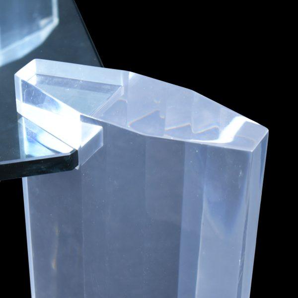 A vintage lucite coffee table in the style of Karl Springer, its thick clear acrylic construction reading as pure,...