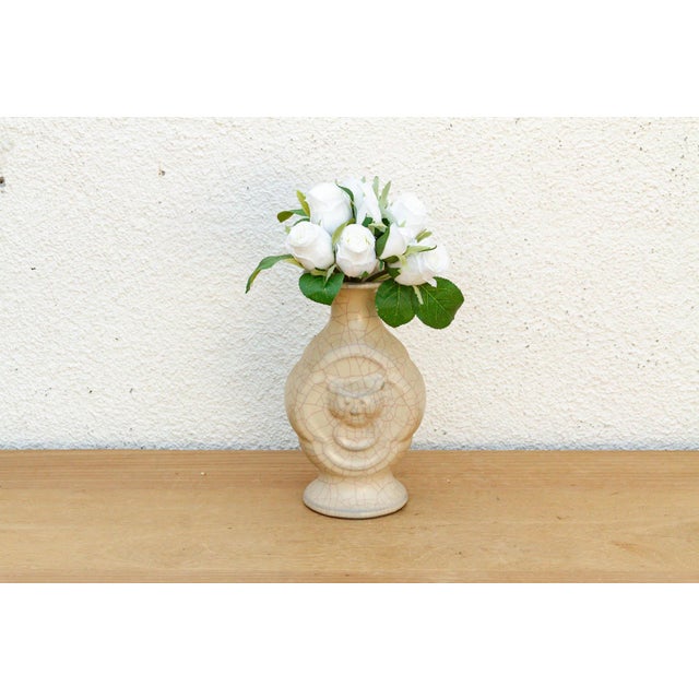 This ceramic vase features a classical pilgrim-flask silhouette, distinguished by relief-molded ring handles and a high-...