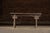 Antique low wooden bench with shaped apron. Handcrafted East Asian vernacular bench featuring a single-plank top over...