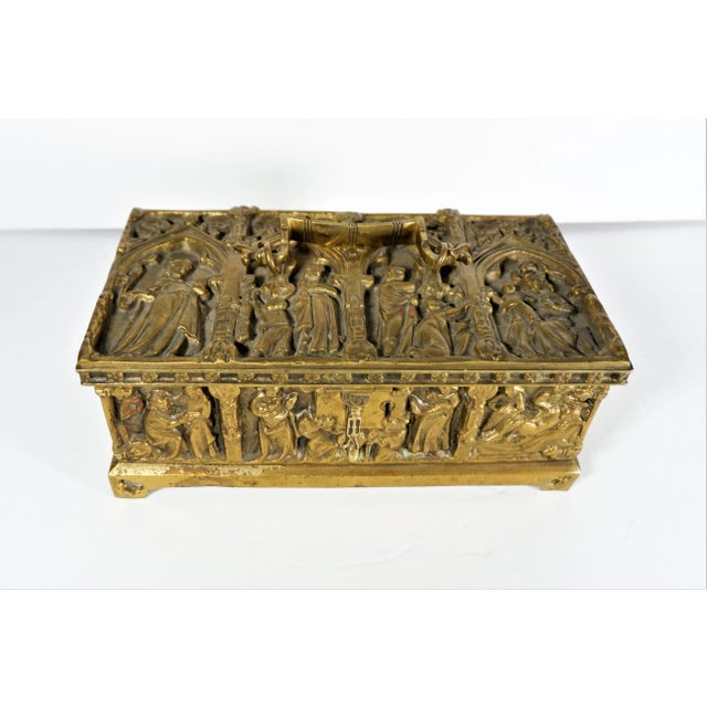 A vintage mid-century brass relic casket box. Casket boxes were used for storing important relic items. Box depicts human...