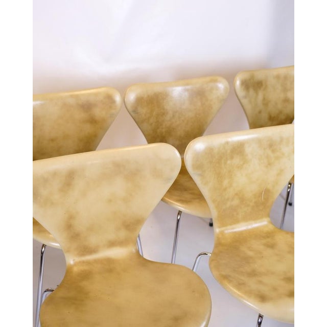 Set of eight syver chairs produced by fritz hansen. The chairs are upholstered in beautifully patinated natural-colored...