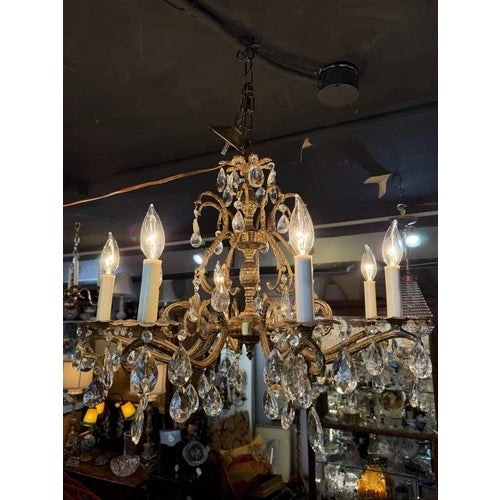 Vintage Brass & Crystal Eight Light French Style Chandelier with Center Pineapple Motif. Very fine condition and in fully...