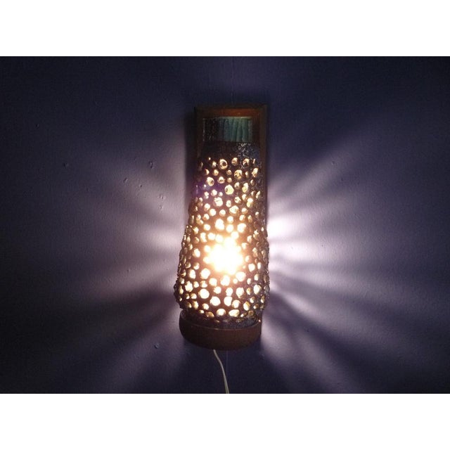 This ceramic wall lamp was designed by Sejer, Denmark. It is clean and functional, remaining in a very good original...