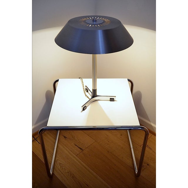 This Scandinavian mid-century desk lamp was designed by Jo Hammerborg for Fog & Mørup. The lamp is made of aluminum with...