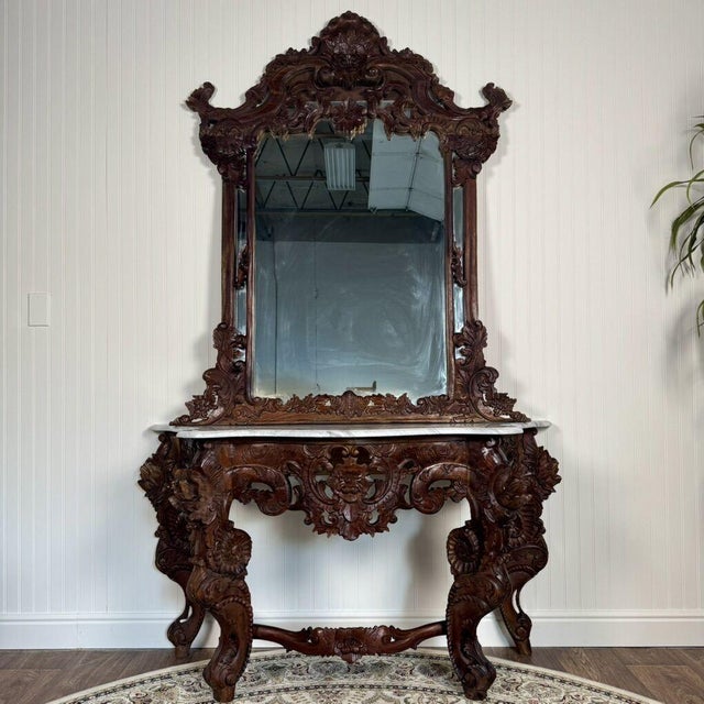 Beautiful vintage Rococo/Victorian Revival console table with matching wall mirror, featuring a dark, rich wood tone,...