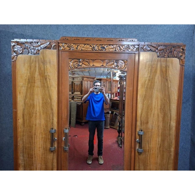 Beautiful three-door art deco wardrobe in fruitwood veneer, dating from the 1930s. this elegant piece is characterized by...